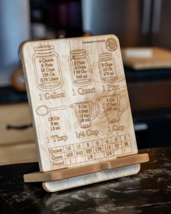 Hard maple cookbook stand on a kitchen counter, engraved measurement conversion chart facing out.
