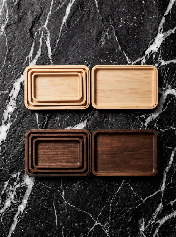 Handmade set of four nesting wooden trays in maple or walnut.
