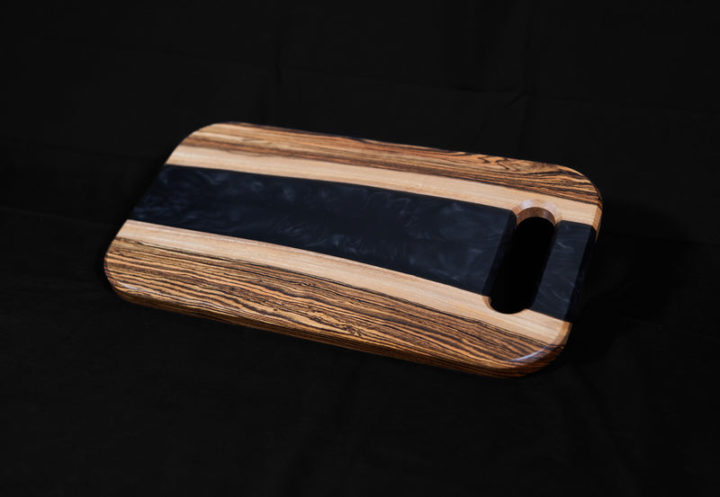 Bocote River Charcuterie Board by Kineo Mountain Woodsmithing, 18x10 inches, featuring a rich wood grain and river design.
