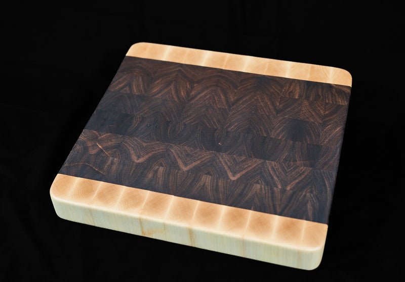 Black walnut and hard maple end grain butcher block measuring 17x16 inches by Kineo Mountain Woodsmithing.