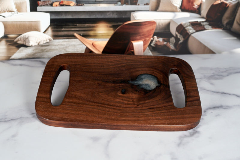 Black walnut charcuterie board from Kineo Mountain Woodsmithing, 13x9 inches, showcasing its smooth, polished surface and natural wood grain.