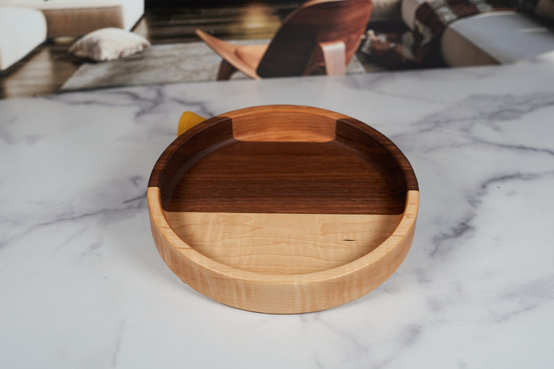 Black Walnut, Maple, and Cherry catchall tray by Kineo Mountain Woodsmithing, 9.5-inch round wood organizer on a white background.