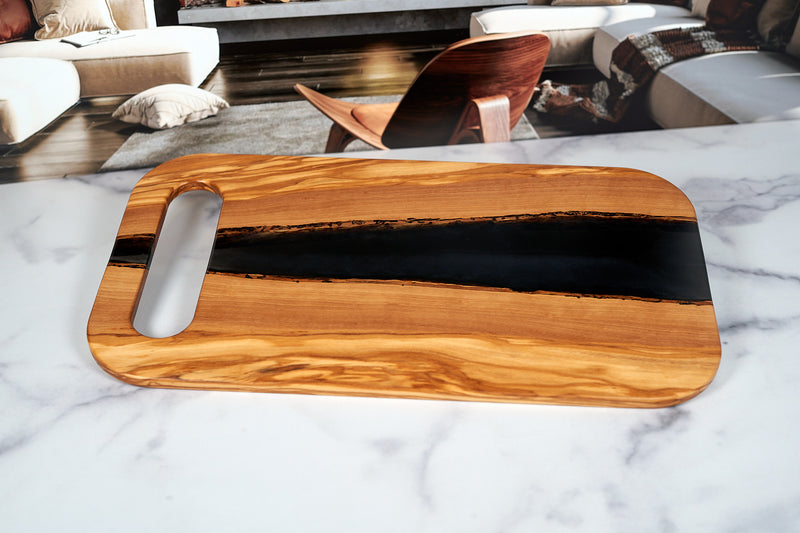 Olivewood River Charcuterie Board by Kineo Mountain Woodsmithing, 18-inch by 10-inch serving platter with natural wood grain design.