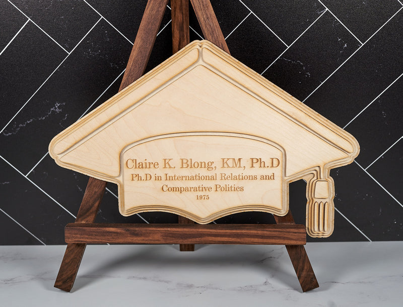 Wooden college degree wall art by Kineo Mountain Woodsmithing featuring engraved commemorative design on natural wood decor.