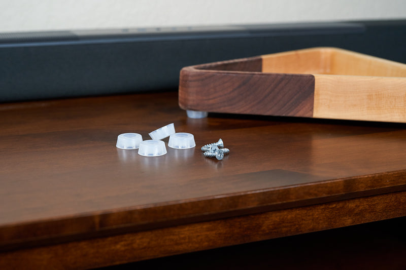 Clear rubber feet by Kineo Mountain Woodsmithing, showing close-up of transparent, durable rubber pads for furniture stability.
