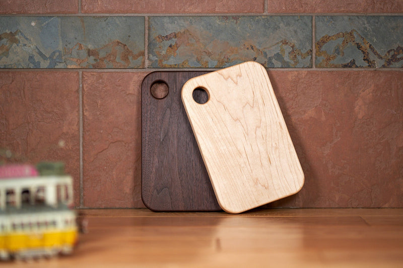 Kineo Mountain Woodsmithing Mt. Elbert mini cutting board made of wood, showing its compact size and smooth finish.