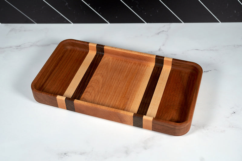 Black walnut, cherry, and hard maple serving tray by Kineo Mountain Woodsmithing, 14x7 inches, with a polished finish and handcrafted design.