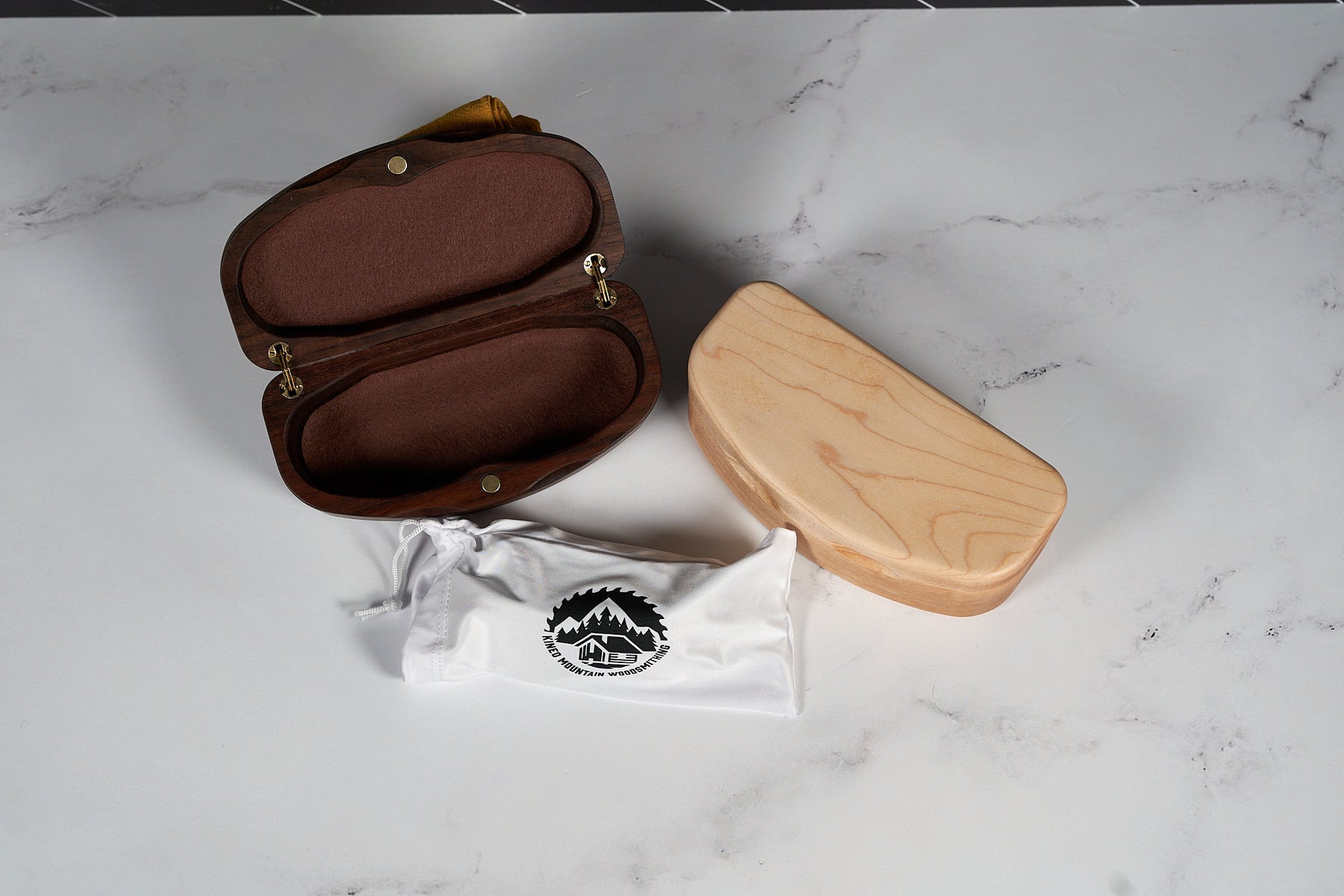 Kineo Mountain Woodsmithing sunglasses case made of wood with a smooth finish, designed to protect eyewear.