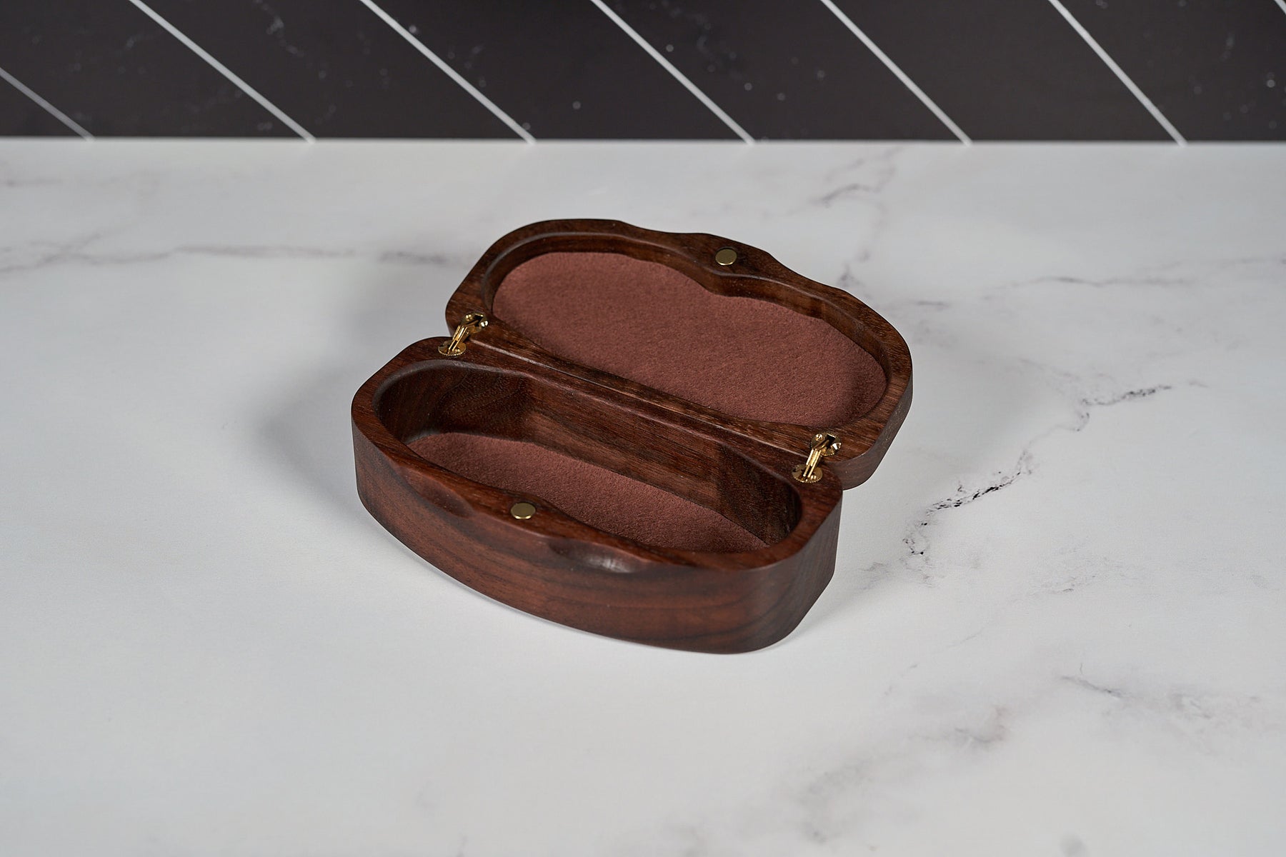 Kineo Mountain Woodsmithing sunglasses case made of wood, with a natural finish, designed to protect and store sunglasses.