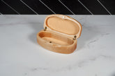 Kineo Mountain Woodsmithing sunglasses case in natural wood finish, with smooth, rounded edges and secure clasp for protection.