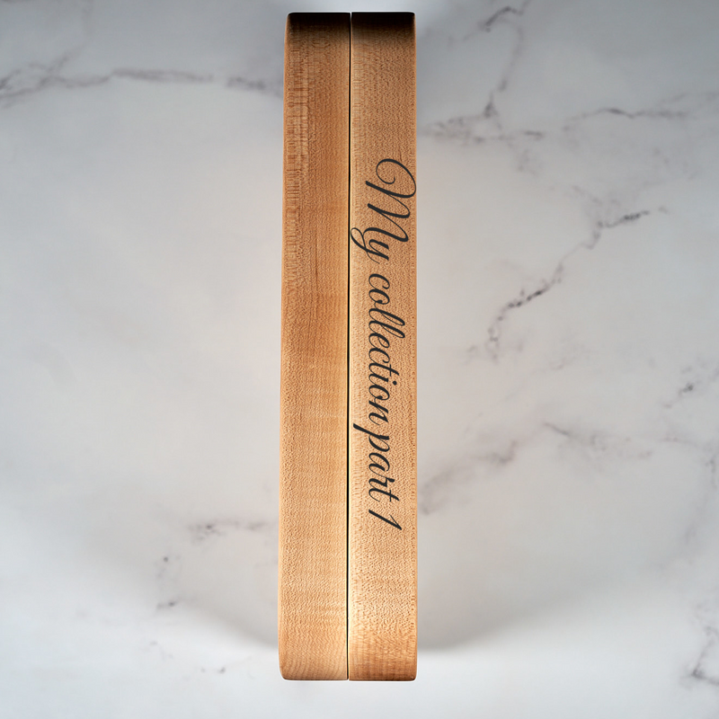 Custom laser engraved jewelry book spine by Kineo Mountain Woodsmithing, showcasing detailed engraved text on wood.