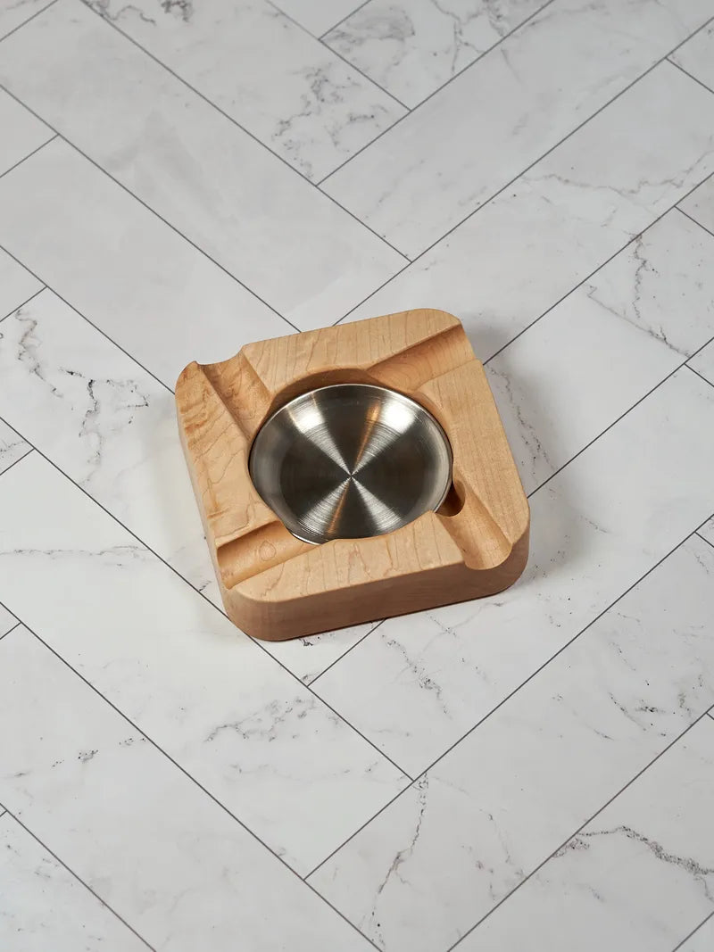 Top-down view of a hard maple cigar ashtray with a round brushed stainless steel dish.
