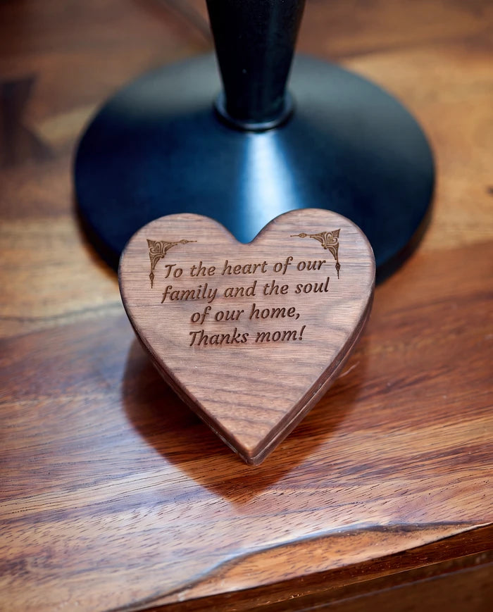 Maple heart-shaped keepsake box standing upright with a custom message engraved on the lid.