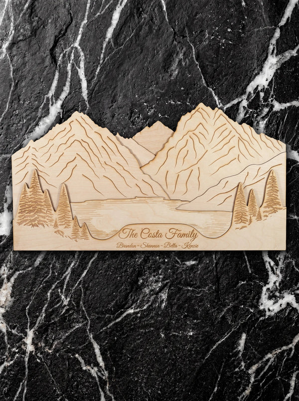 Personalized family name mountain wall art in layered Baltic birch.