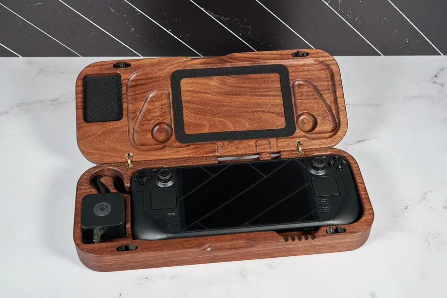 Walnut travel case open on a marble counter with a Steam Deck inside.