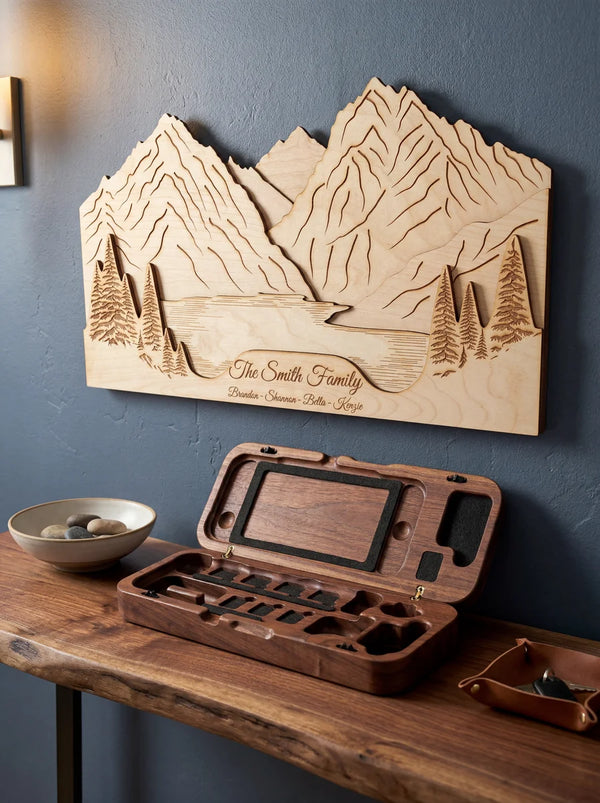 Open walnut Switch 2 case on wooden console table in front of personalized wood mountain landscape wall art on blue wall.