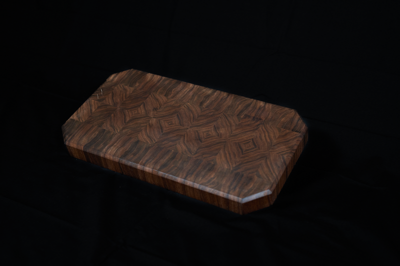 Black Walnut end grain cutting board by Kineo Mountain Woodsmithing, 18x9 inches, showing smooth polished surface and rich wood grain.